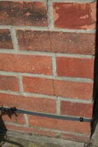 Brick wall showing crack pattern near window