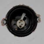 View looking up into a JCC downlight fitting showing the lampholder and spring clips