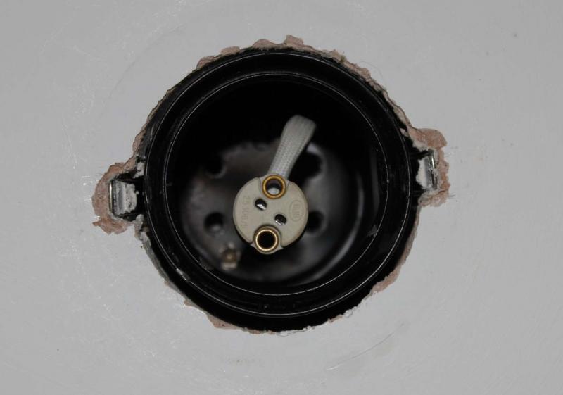 View looking up into a JCC downlight fitting showing the lampholder and spring clips