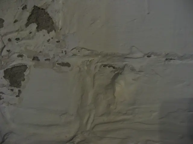 10a Fireplace Wall Stucco and Plaster Close Up.JPG