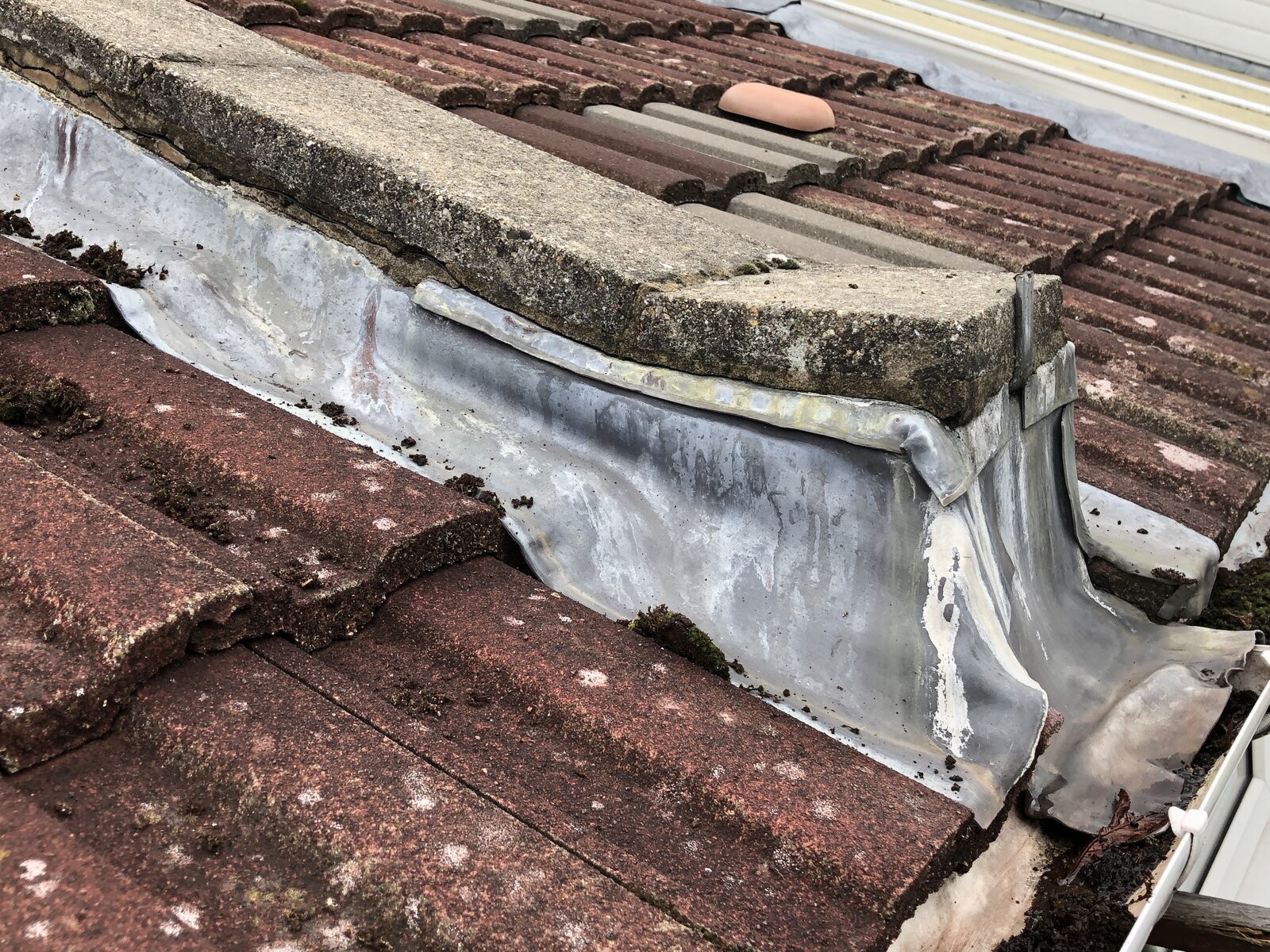 Help needed with replacing coping stones on a shared firewall with roof
