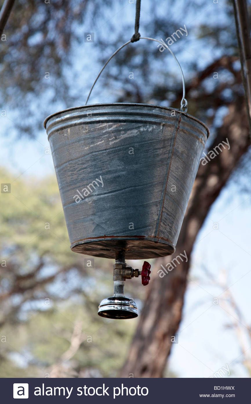 bucket-shower-used-by-tourists-on-luxury-mobile-tented-safaris-in-BD1HWX.jpg