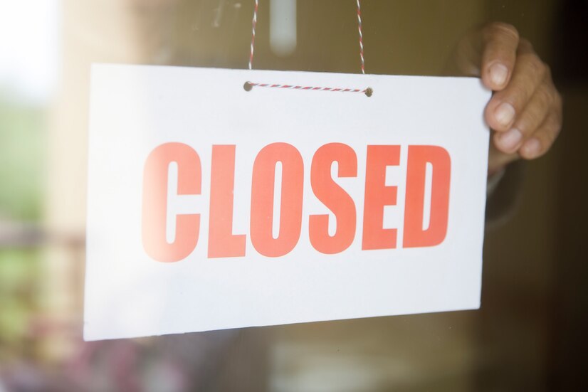 business-store-owner-turning-closed-sign-shop-doorway_52137-31876.jpg