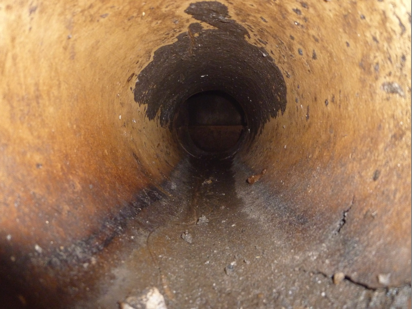 Inside Clay pipe embedded in brick wall - peering into sewer.jpg