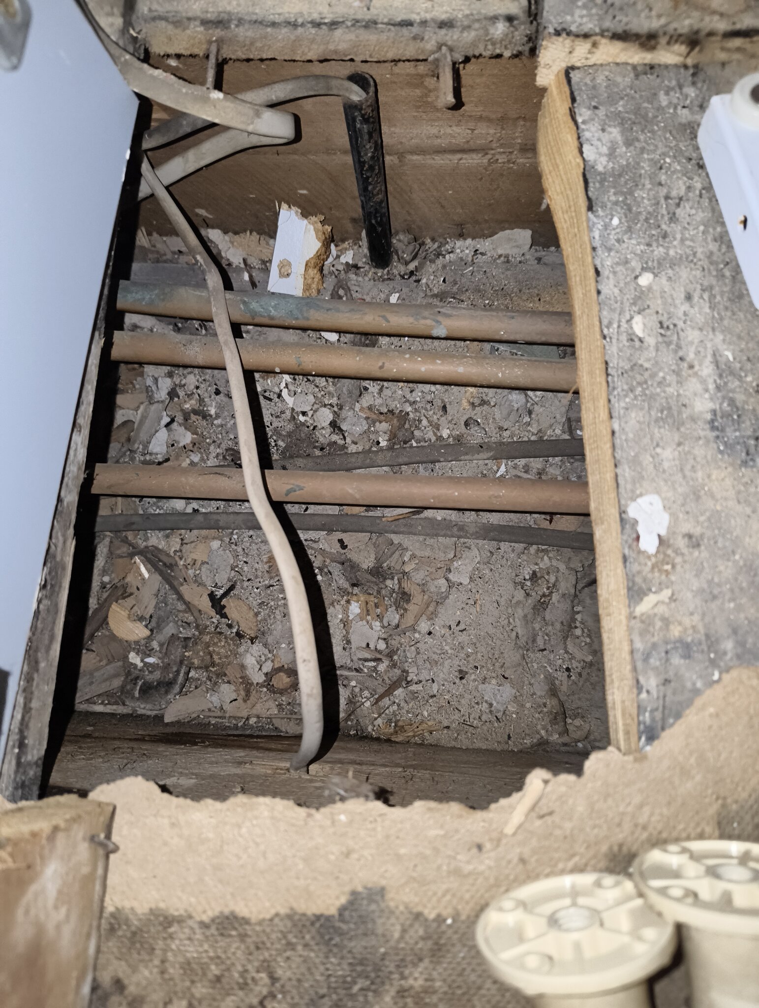 Under boards in kitchen pipes.jpg