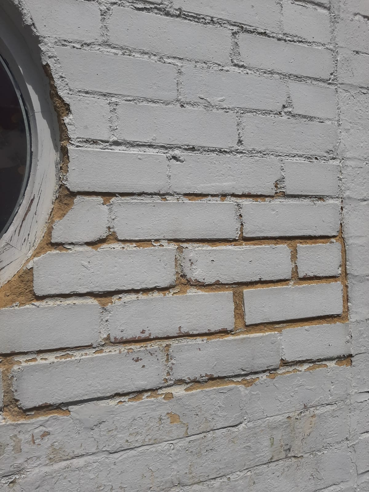 Best way to stabilise sandy mortar in between bricks on wall before