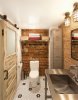 Salvaged-decor-shapes-small-industrial-bathroom-with-exposed-brick-walls.jpg