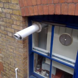 Flue through a glass window