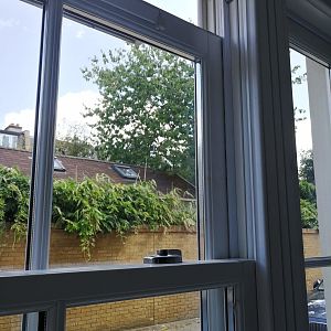 Top sash slides down after unlocking