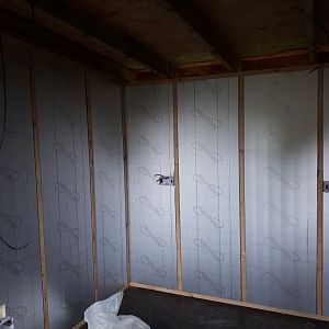 fitting the wall insulation, first electrical fix going in as well