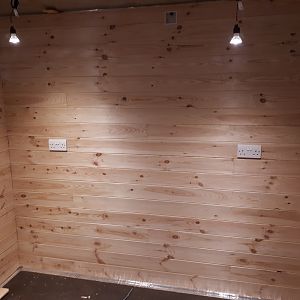 knotty pine TGV cladding going in the gym side