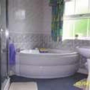 ceramic bathroom with corner bath