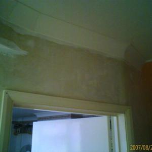 Over the top of doorway into front room.