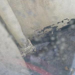 Looking out window at drain pipe