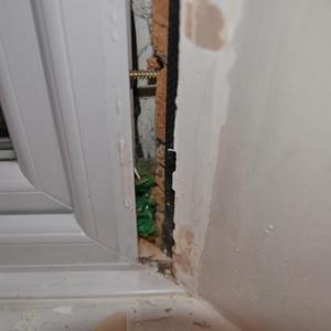 Large gap - stuffed with green plastic bag