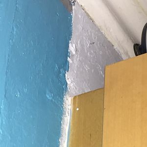 Top of brown board on side of chimney