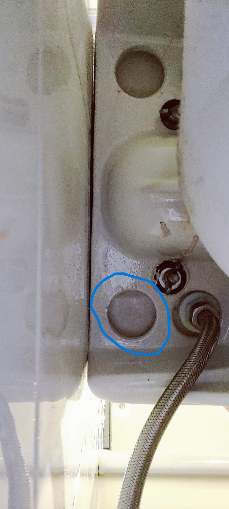 Blue circle shows where the water is leaking from