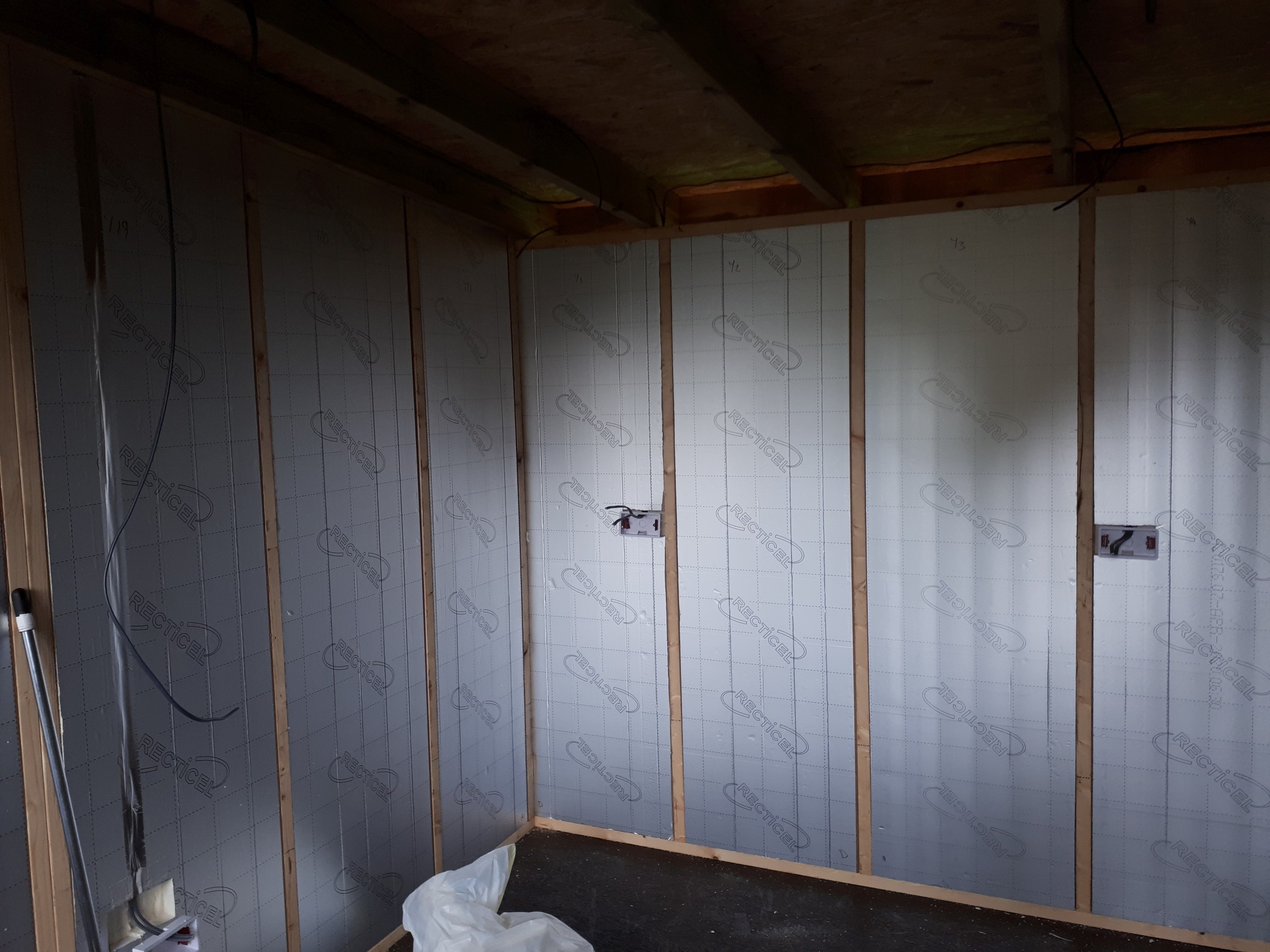 fitting the wall insulation, first electrical fix going in as well