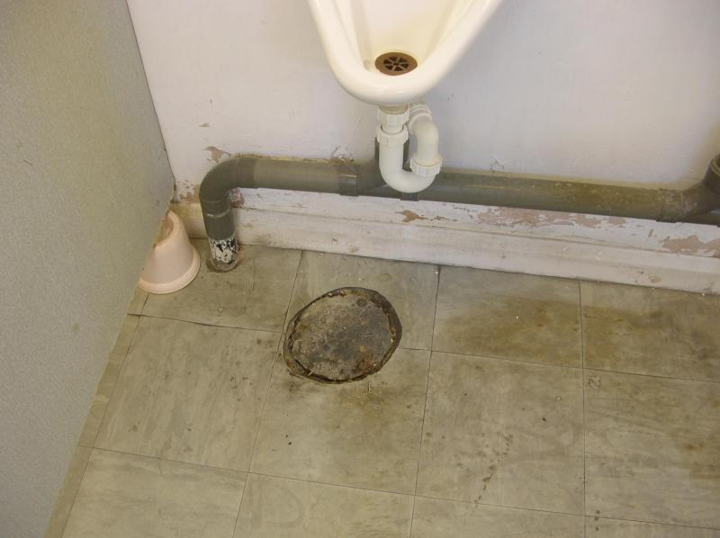 Hole below urinal