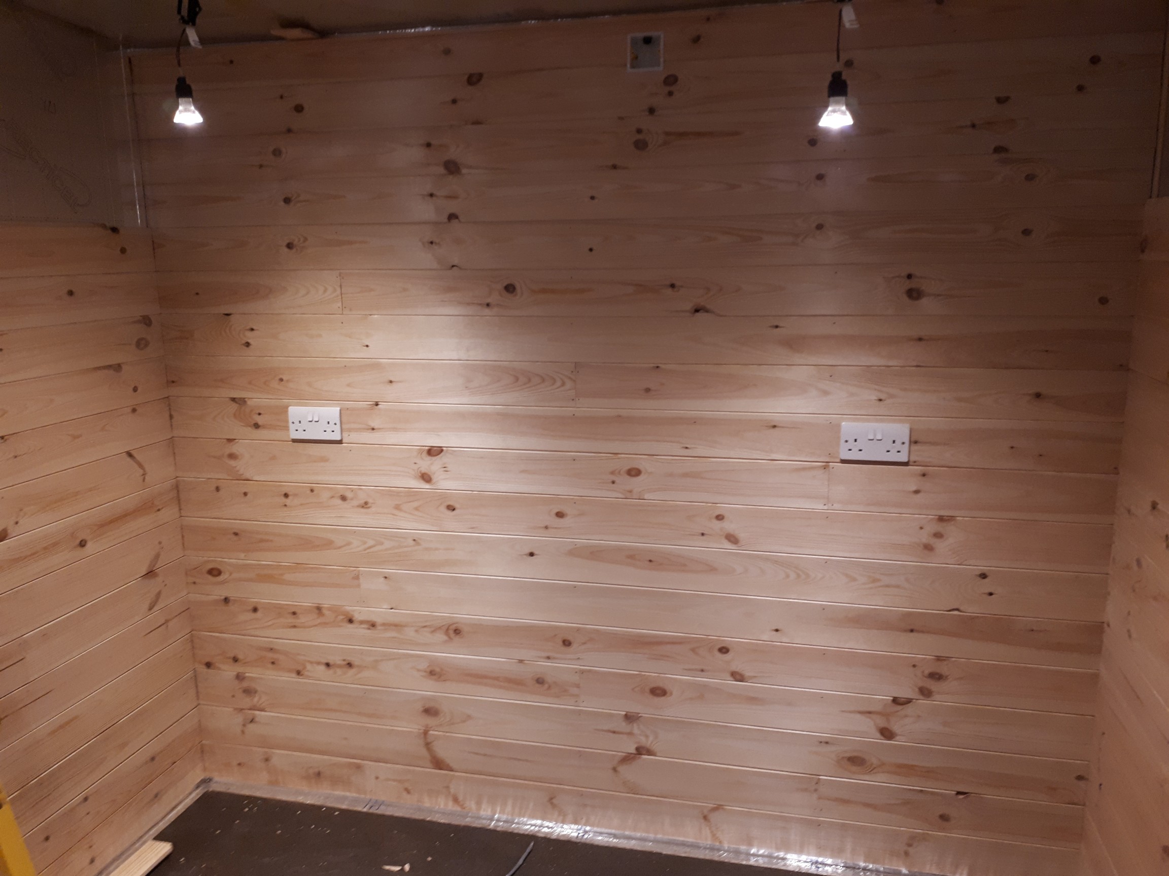 knotty pine TGV cladding going in the gym side