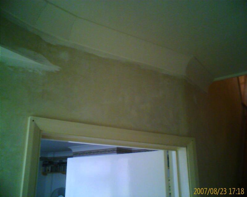 Over the top of doorway into front room.