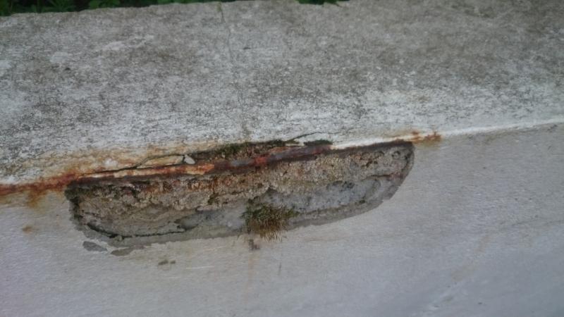 rusting metal edge pushed out cement