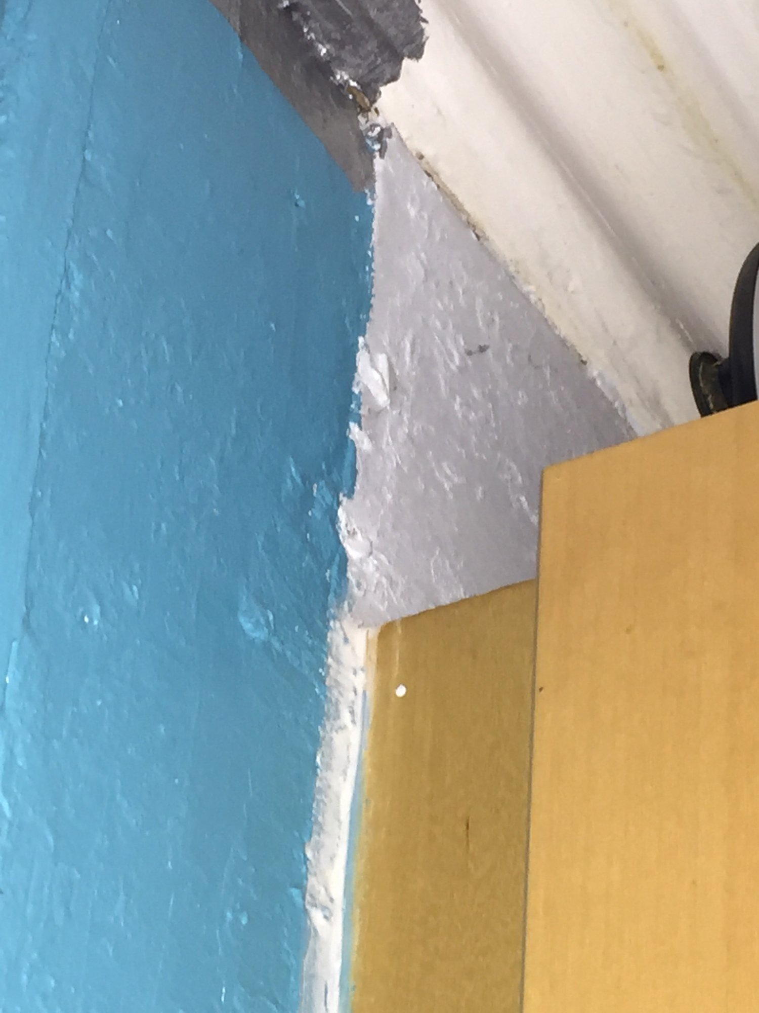 Top of brown board on side of chimney